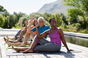 Seniors practicing Mature Movers Yoga in dock in Lake Chelan sunshine